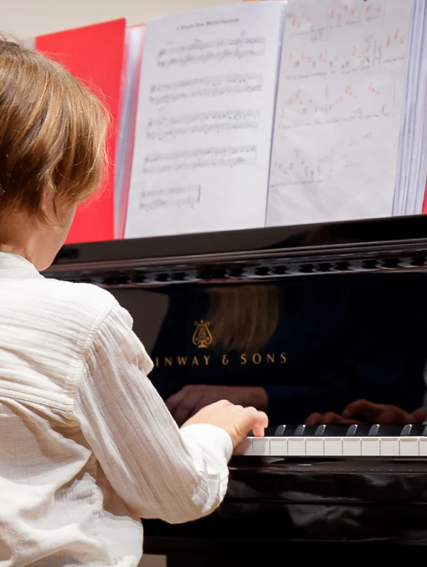 boy receiving a piano lesson in dubai