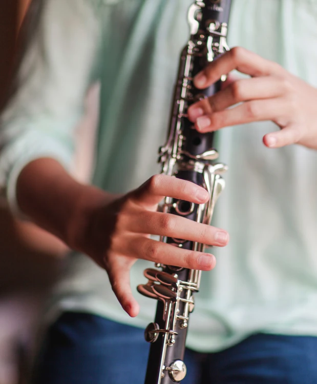 closeup of hands playing the clarinet