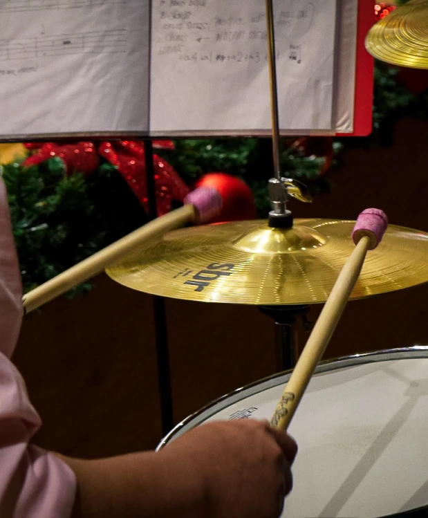 A person playing the drums at Oohlala Fine Arts.