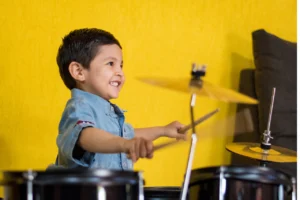 Coordination and rhythm on drums - child learning to play