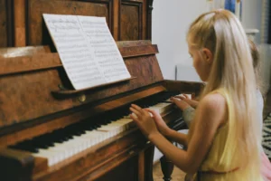 Kid learning piano - child playing the piano.