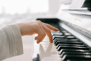 Woman's hand playing the piano.