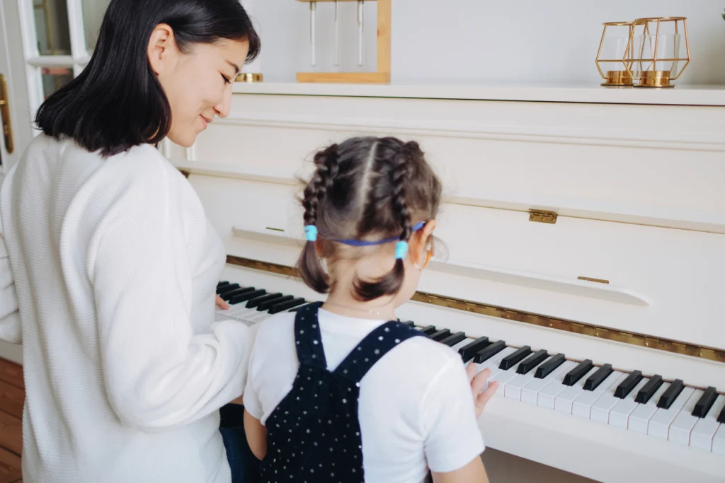 Piano teacher - instructor guiding a student.